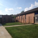 The existing sidewalk must be removed to make way for the expanded Narthex. Also notice that the fencing, previously screening the HVAC units, has been carefully dismantled so that it can be reused in another location.