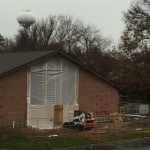 The old exterior wall of the original church building is being removed to be replaced by solid glass, allowing natural light to enliven the new Parish Center.